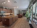 Open-concept kitchen featuring granite countertops, an island, and stainless steel appliances at 21013 W Wycliff Dr, Buckeye, AZ 85396