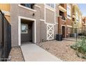 Inviting walkway leads to the townhouse entrance, featuring stone accents and low-maintenance landscaping at 22125 N 29Th Ave # 158, Phoenix, AZ 85027
