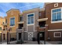 Inviting townhouse featuring colorful facade, gated entrance, and small patios for outdoor enjoyment at 22125 N 29Th Ave # 158, Phoenix, AZ 85027
