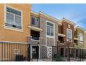The inviting townhouse exterior features colorful facades, gated entry, and a well-maintained landscape at 22125 N 29Th Ave # 158, Phoenix, AZ 85027