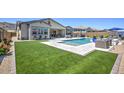 Beautiful backyard with lush lawn, pool, outdoor seating, and desert landscaping at 3118 E Gary Way, Phoenix, AZ 85042
