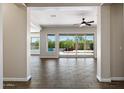 Bright living room featuring wood-look tile floors and sliding glass doors to the outdoor pool area at 31409 N 58Th Pl, Cave Creek, AZ 85331