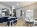 Kitchen features a kitchen island with bar stool seating and an eat-in dining space at 363 W Bruce Ave, Gilbert, AZ 85233