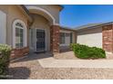 Inviting front entrance with brick columns, arched entryway, security door and well-maintained landscaping at 3646 E Rousay Dr, San Tan Valley, AZ 85140