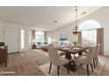 Open-concept living and dining area with vaulted ceilings and ample natural light showcases modern elegance and comfortable living at 3646 E Rousay Dr, San Tan Valley, AZ 85140
