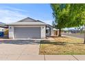 Charming single-story home with a well-manicured lawn and an attached two-car garage at 3651 W Escuda Dr, Glendale, AZ 85308
