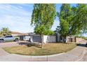 Charming single-story home with a well-manicured lawn and an attached two-car garage at 3651 W Escuda Dr, Glendale, AZ 85308