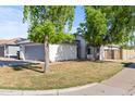 Charming single-story home with a well-manicured lawn and an attached two-car garage at 3651 W Escuda Dr, Glendale, AZ 85308