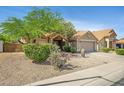 Charming house with desert landscaping, mature trees, and a tile roof in a well-kept neighborhood at 4131 E Cascalote Dr, Cave Creek, AZ 85331