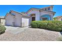 Single story home showcasing desert landscaping, a spacious three-car garage, and neutral color palette at 43561 W Snow Dr, Maricopa, AZ 85138