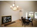 Dining room featuring tile and carpet flooring, neutral paint, and chandelier at 44865 W Woody Rd, Maricopa, AZ 85139
