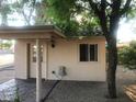 Back house features covered porch, exterior lighting, and small window at 5333 W Dublin Ct, Chandler, AZ 85226