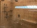 Modern shower features tile, glass doors, shower head, and a window at 5333 W Dublin Ct, Chandler, AZ 85226