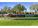 Community entrance with stone wall, lush landscaping, and a 'Montevista' sign at 5434 E Barwick Dr, Cave Creek, AZ 85331