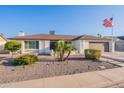 Charming single-story home featuring a landscaped front yard and an American flag at 603 W Keats Ave, Mesa, AZ 85210