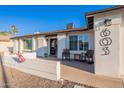 Inviting front porch with chairs and a modern door, perfect for relaxing outdoors at 603 W Keats Ave, Mesa, AZ 85210