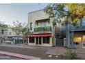 Stylish commercial building with second story balcony adorned with vibrant green plants at 610 E Roosevelt St # 145, Phoenix, AZ 85004
