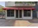 Close-up of the building's entrance with the distinctive red and white striped awning at 610 E Roosevelt St # 145, Phoenix, AZ 85004
