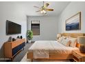 Cozy bedroom with a comfortable bed, modern furnishings, and a ceiling fan for added comfort at 6255 S Opal Dr, Chandler, AZ 85249