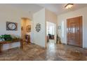 Welcoming foyer showcasing tile flooring, an elegant front door, and a view into the office at 6931 S Four Peaks Way, Chandler, AZ 85249