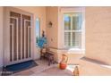 Inviting front porch with decorative details, including a stylish door and complementing window at 6931 S Four Peaks Way, Chandler, AZ 85249