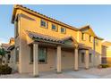 Stylish two-story residence featuring a tiled roof, covered porch, and well-maintained desert landscaping at 822 E Agua Fria Ln, Avondale, AZ 85323