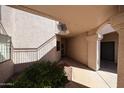 The shady entry to this unit features desert landscaping with a sidewalk leading to the front door at 9151 W Greenway Rd # 162, Peoria, AZ 85381