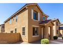 Inviting two-story home with desert landscaping, tile roof, and a welcoming front entrance at 917 E Agua Fria Ln, Avondale, AZ 85323