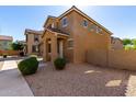 Two-story home with a covered entry, desert landscaping, and a tile roof, radiating charm at 917 E Agua Fria Ln, Avondale, AZ 85323