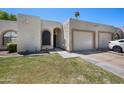 Charming single-story home featuring a well-manicured lawn and attached two-car garage at 9313 W Morrow Dr, Peoria, AZ 85382