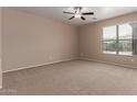 Neutral bedroom with carpet, ceiling fan, and a window with blinds at 10009 W Raymond St, Tolleson, AZ 85353