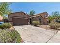 Inviting exterior of a one-story home featuring a spacious driveway and low-maintenance landscaping at 10009 W Raymond St, Tolleson, AZ 85353