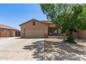 Single-story tan home featuring a two-car garage and manicured landscaping in a suburban neighborhood at 10735 E Kilarea Ave, Mesa, AZ 85209
