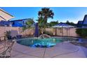Backyard oasis featuring a sparkling pool, tropical plants, and inviting patio area at 1085 E Oakland Ct, Gilbert, AZ 85295
