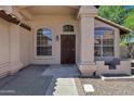 Welcoming front porch featuring a decorative front door, arched windows, and stone accents at 1245 W Cindy St, Chandler, AZ 85224