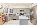 Bright, open kitchen featuring modern stainless steel appliances and gray cabinetry at 1451 E South Fork Dr, Phoenix, AZ 85048