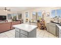 Modern kitchen with island, stainless steel appliances and ample natural light and a connecting Living Room at 1451 E South Fork Dr, Phoenix, AZ 85048