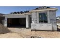 Under construction home with garage, window and partially installed roof at 18224 W La Senda Dr, Surprise, AZ 85387