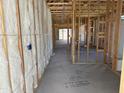 Interior framing with insulation, showcasing the layout and potential of the home at 18224 W La Senda Dr, Surprise, AZ 85387