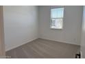 Clean, carpeted bedroom features a window that provides natural light at 18240 W La Senda Dr, Surprise, AZ 85387