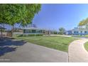 Inviting single-story home with a spacious lawn, providing a welcoming entrance and ample outdoor space at 1917 W Ashland Ave, Phoenix, AZ 85009