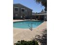 Community pool with dolphin figure, metal grab rail surrounded by lush greenery at 2301 E University Dr # 111, Mesa, AZ 85213