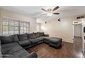 Bright living room featuring a large sectional couch, hardwood floors and lots of natural light at 255 N Hunt E Dr, Mesa, AZ 85203