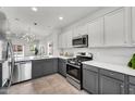 Modern kitchen boasts stainless steel appliances, white countertops, and gray and white cabinetry at 2759 E Mews Rd, Gilbert, AZ 85298