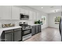 Stylish kitchen with white countertops, stainless steel appliances, and gray and white cabinets at 2759 E Mews Rd, Gilbert, AZ 85298