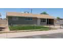Single story home with neutral siding, brown roof, chain link fence, and an arid lawn at 3802 W Mulberry Dr, Phoenix, AZ 85019