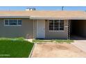 Close up of the front entrance featuring faux grass and an arid lawn at 3802 W Mulberry Dr, Phoenix, AZ 85019