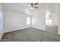 Cozy bedroom with neutral carpet, a ceiling fan, and a window providing ample natural light at 4144 N 109Th Ave, Phoenix, AZ 85037