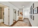 Bright hallway with hardwood floors, showcasing built-in storage and stylish decor at 4243 E Avalon Dr, Phoenix, AZ 85018