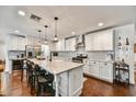 Spacious kitchen featuring a large marble island, stainless steel appliances, and sleek white cabinetry at 4243 E Avalon Dr, Phoenix, AZ 85018